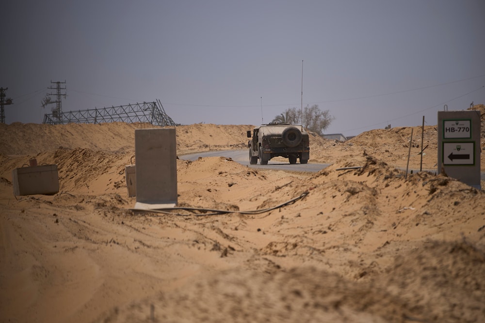 Israeli army vehicles transport a group of soldiers and journalists along the Morag corridor in southern Gaza on June 8, 2025. The Israeli military invited reporters for a tour in the European Hospital in Khan Younis. (AP)