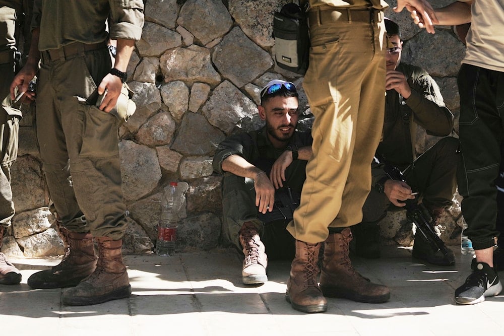 A soldier reacts to speeches made at the funeral for Israeli Defense Forces Staff Sgt. Staff Sergeant Noam Aharon Musgadian, in occupied al-Quds, Palestine, Tuesday, July 8, 2025 (AP)