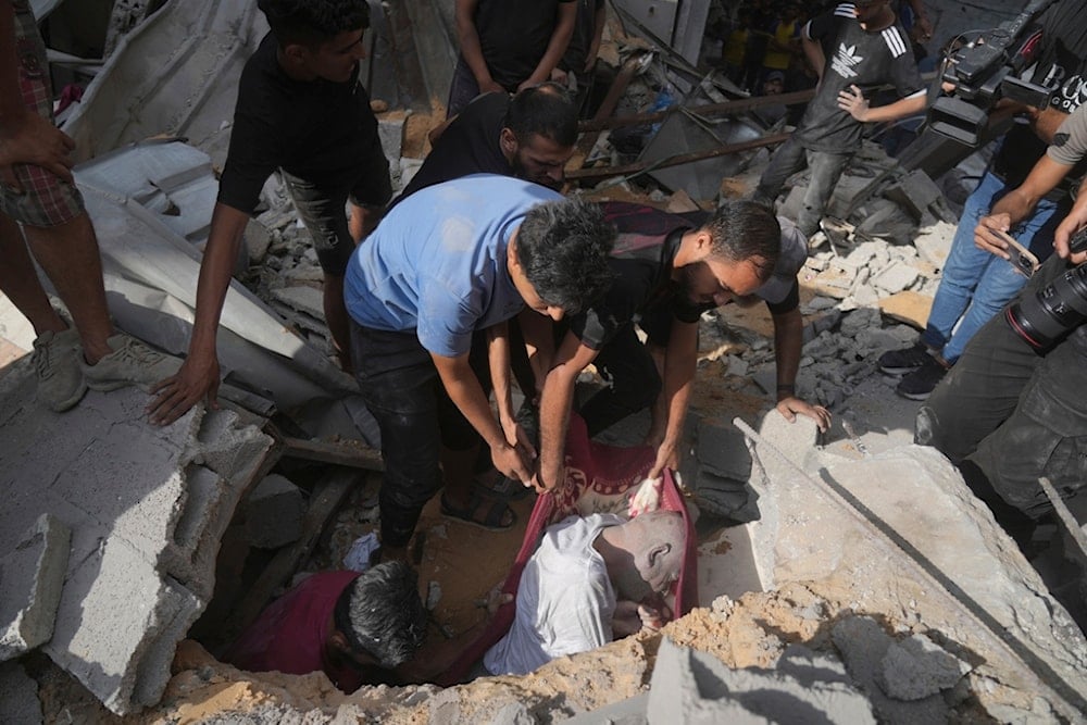 The body of a man is recovered from the rubble of a house following an Israeli military strike in Gaza City, Tuesday, July 15, 2025. (AP Photo/Jehad Alshrafi)
