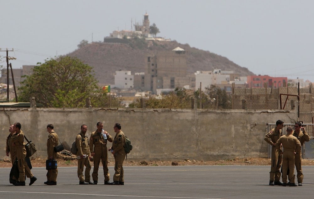 Members of a French military flight crew talk on the tarmac at France's military air base in Dakar, Senegal, between flights toward the presumed site of the crash of a missing Air France flight Tuesday, June 2, 2009 (AP)