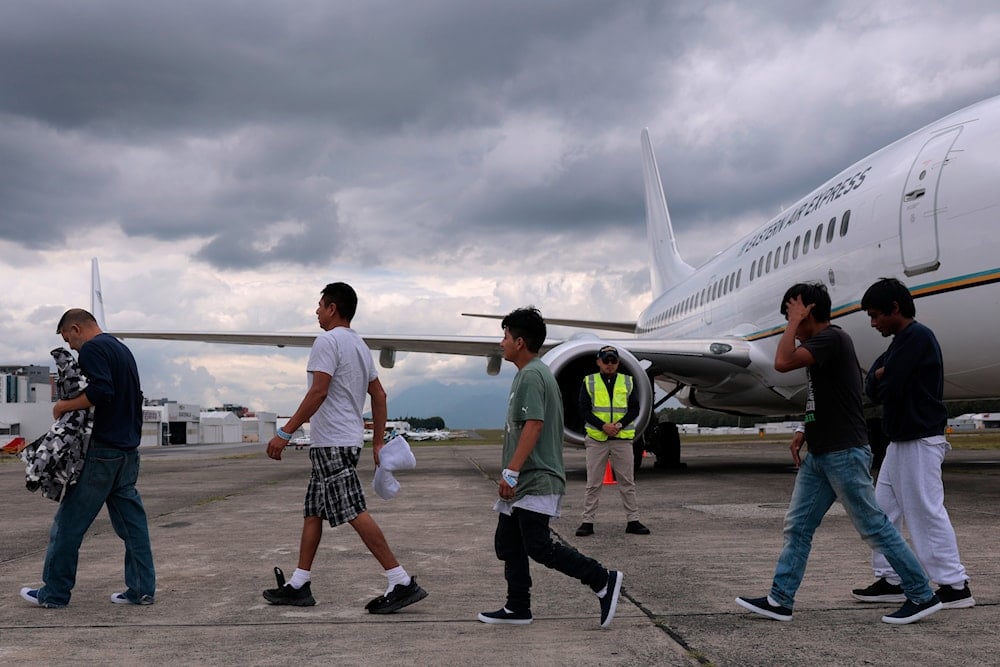 People deported from the United States disembark from a repatriation flight at La Aurora International Airport in Guatemala City, Thursday, June 26, 2025 (AP)