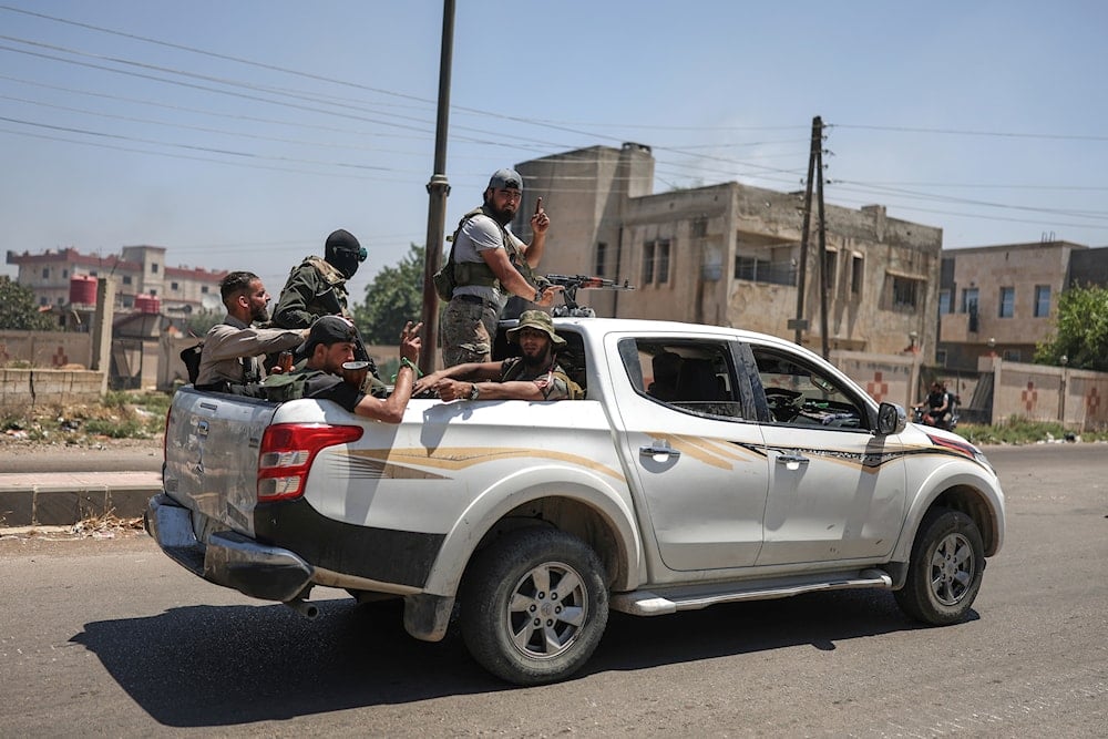 Bedouin fighters deploy at Mazraa village on the outskirts of Sweida city, during clashes between the Bedouin clans and Druze militias, southern Syria, Friday, July 18, 2025 (AP)