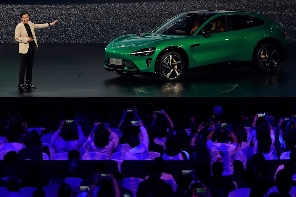 Xiaomi founder Lei Jun show the Xiaomi YU7, a high performance luxury SUV, at a launch event held in Beijing on Thursday, May 22, 2025 (AP)