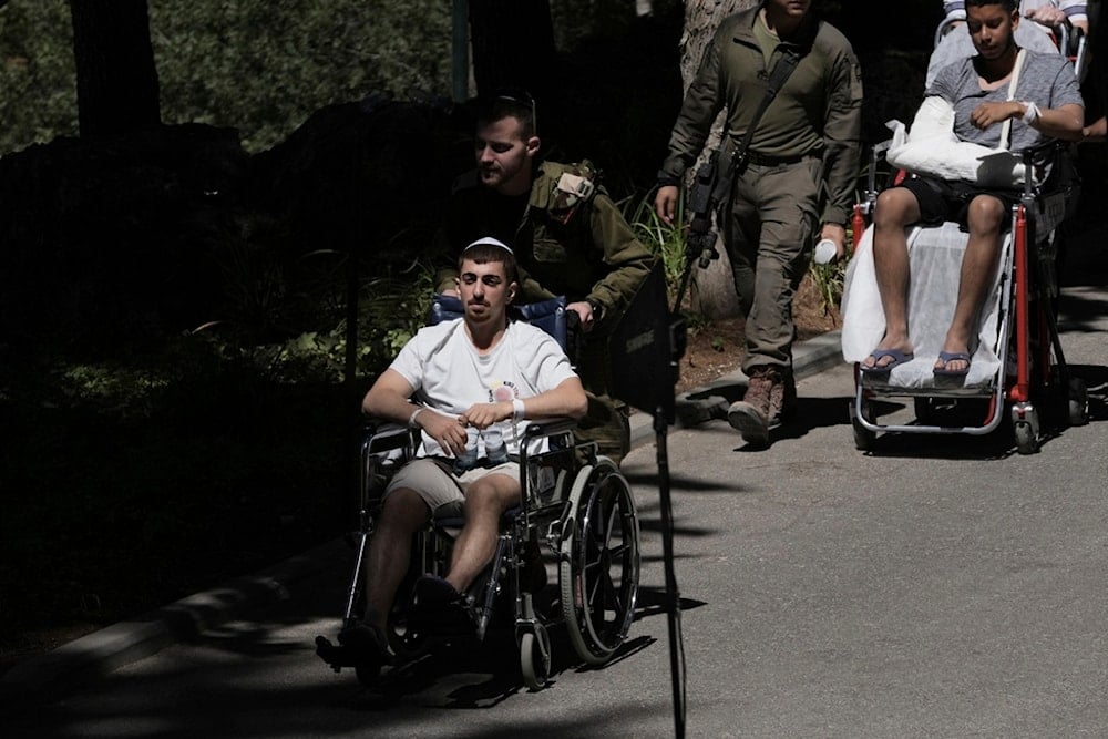 Wounded soldiers arrive for the funeral of an Israeli staff sargeant who was killed in action in the Gaza Strip, at Mt. Herzl Military Cemetery in occupied al-Quds, occupied Palestine, Tuesday, July 8, 2025 (AP)