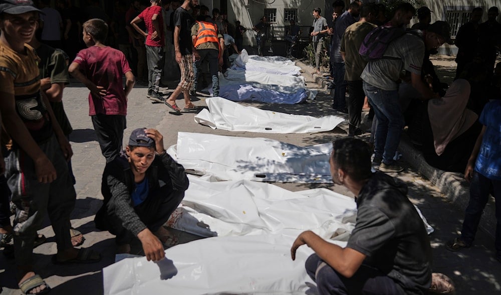 The bodies of Palestinians who were killed while attempting to access aid trucks entering northern Gaza through the Zikim crossing with Israel are brought to a clinic in Gaza City, Sunday, July 20, 2025. (AP Photo/Jehad Alshrafi)