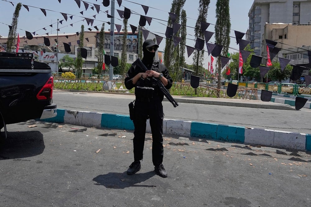 A member of Iran's Revolutionary Guard stands guard at Enqelab-e-Eslami (Islamic Revolution) square in downtown Tehran, Iran, on June 24, 2025. (AP Photo/Vahid Salemi)