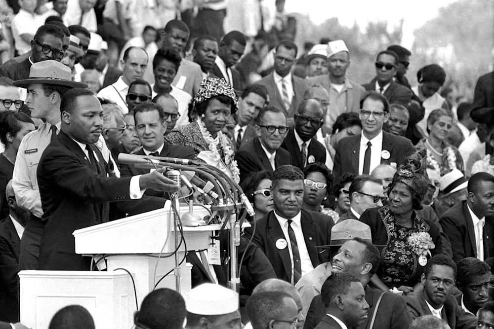 FILE - Martin Luther King Jr., head of the Southern Christian Leadership Conference, speaks to thousands during his 