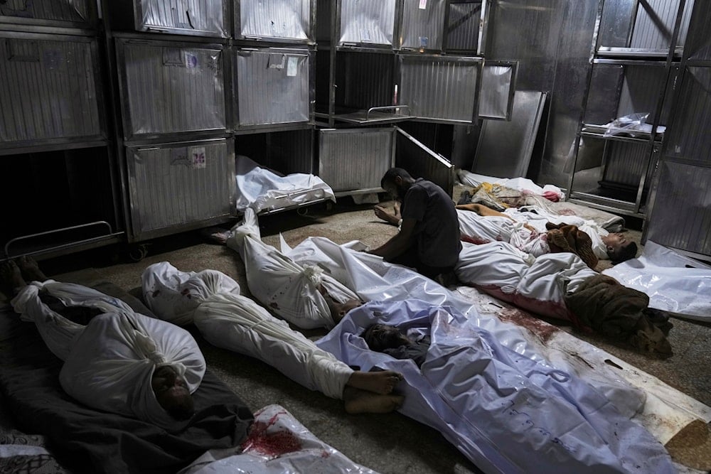 Palestinians mourn their relatives killed from an Israeli army bombardment of Gaza, at the morgue of Shifa Hospital in Gaza City Tuesday, July 22, 2025. (AP)
