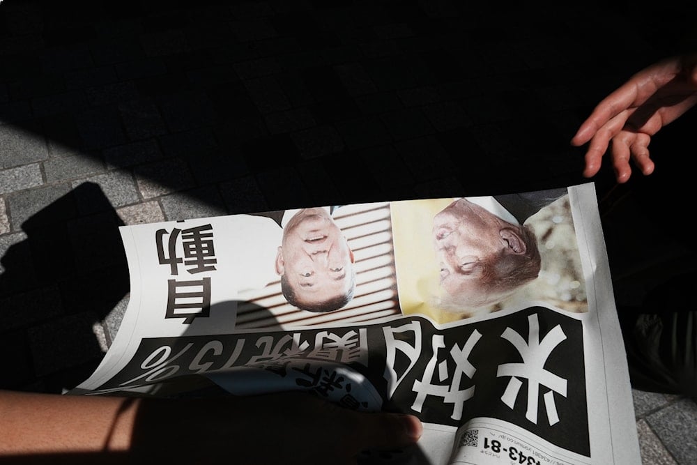 A staff member distributes an extra edition of the Yomiuri Shimbun newspaper reporting that President Donald Trump announced a trade framework with Japan on Tuesday, Wednesday, July 23, 2025, in Tokyo (AP)