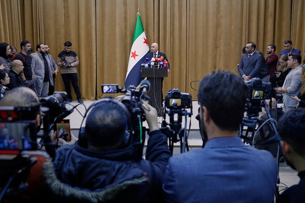 Yaser Farhan, spokesperson for the Syrian investigation committee tasked with probing massacres of the Alawite minority along the Syrian coast, holds a press conference in Damascus, Syria, March 11, 2025 (AP)