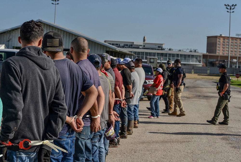 Workers handcuffed after being arrested by US Immigration and Customs Enforcement (ICE) agents at Delta Downs Racetrack on Wednesday, June 18, 2025, in Calcasieu Parish, near Vinton, Louisiana. (U.S. Immigration and Customs Enforcement via AP)