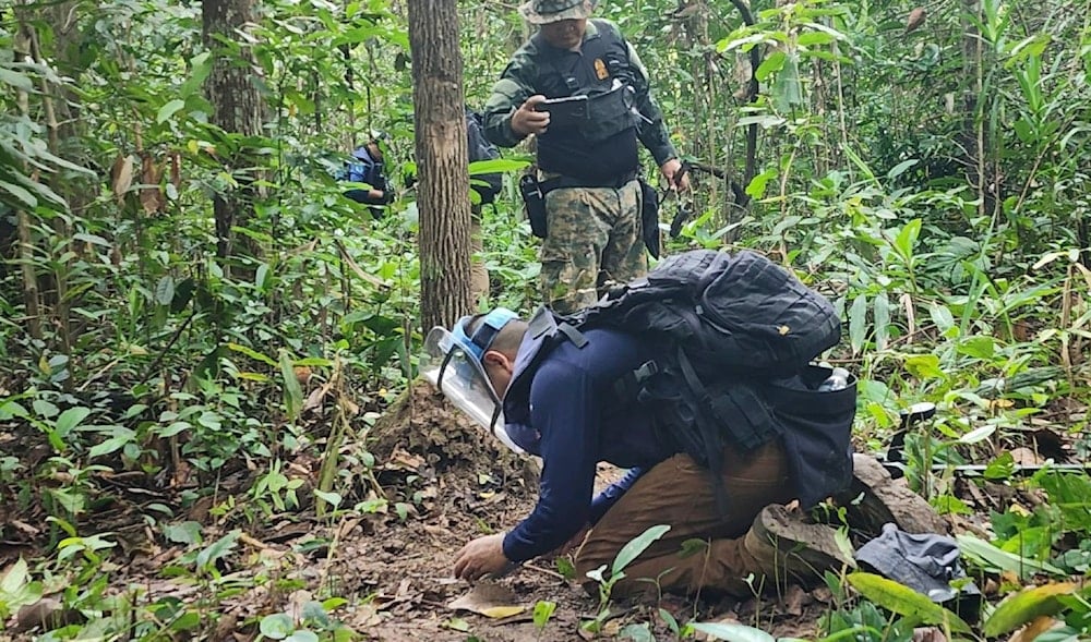 In this Sunday, July, 2025, photo released by the Royal Thai Army, Thai soldiers inspect a border area in Ubon Ratchathani†province where the Royal Thai Army said two anti-personnel landmines were found. (Royal Thai Army via AP)