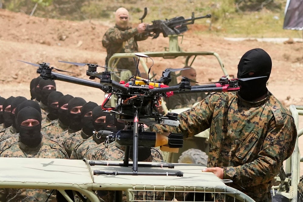 A Hezbollah fighter stands next to an armed drone during a training exercise in Aaramta village in the Jezzine District, southern Lebanon, on May 21, 2023. (AP)