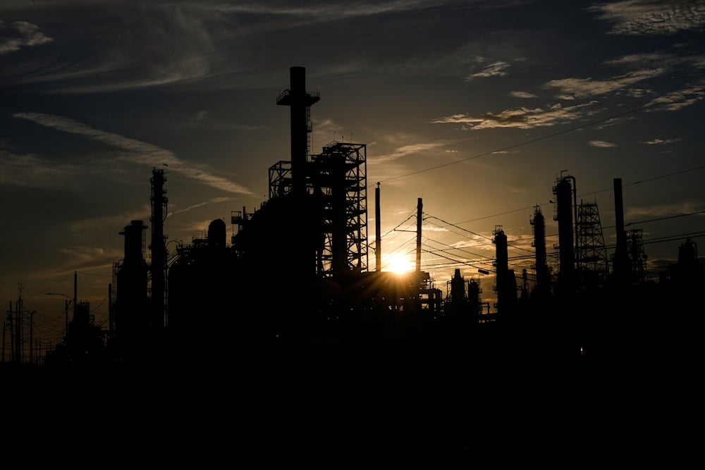 The sun set behind LyondellBasell oil refinery on Sunday, July 20, 2025, in Houston (AP)