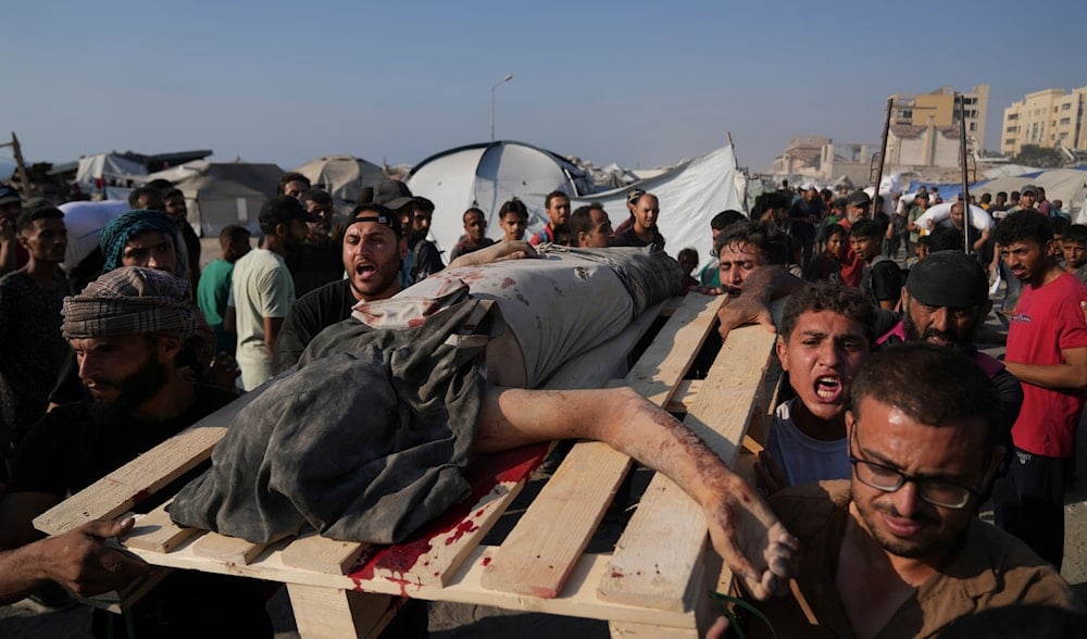 Palestinians carry the body of a man who was hit by a truck while attempting to reach a humanitarian aid convoy that entered Gaza City from the northern Gaza Strip, Saturday, July 26, 2025. (AP)