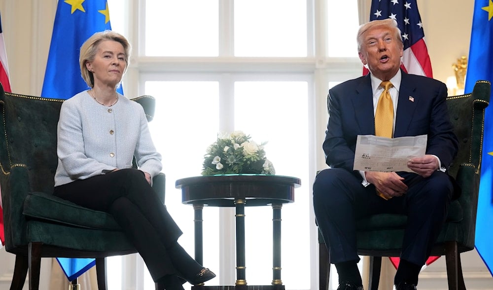 President Donald Trump reads from a paper and European Commission President Ursula von der Leyen listens after reaching a trade deal between the US and the EU at the Trump Turnberry golf course in Scotland, July 27, 2025. (AP)