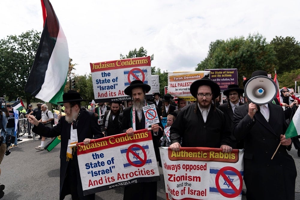 Members of Neturei Karta, an international anti-Zionist ultra-Orthodox Jewish organization, march outside of the US Capitol as they protest the visit of Israeli Prime Minister Benjamin Netanyahu, Wednesday, July 24, 2024, in Washington (AP)