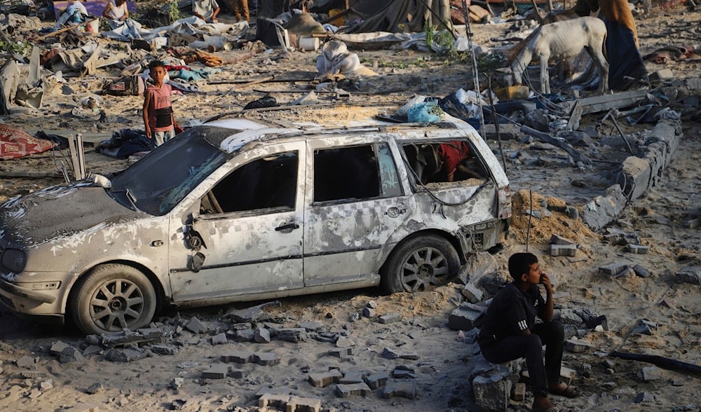 Palestinians inspect the site struck by an Israeli bombardment in Mawasi, Khan Younis, Gaza Strip, Monday, July 28, 2025. (AP)