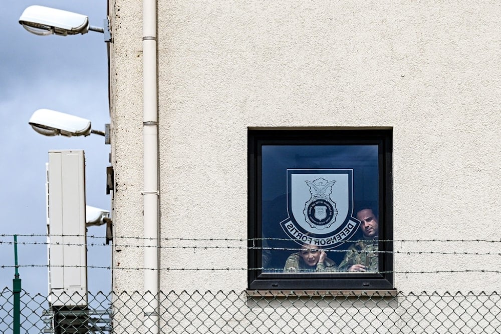 US Air Force Airmen watch from a window as US Vice President JD Vance disembarks Air Force Two upon his arrival at Ramstein Air Base, Germany, Thursday, April 24, 2025 (AP)