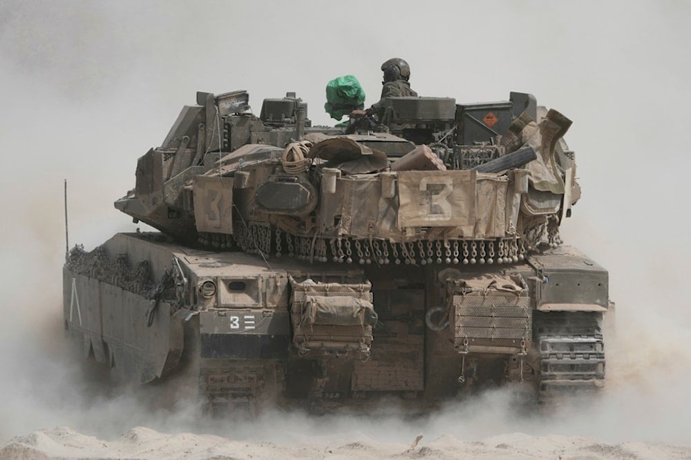 Israeli soldiers move tanks around staging area near the border with the Gaza Strip, Occupied Palestine, Sunday, May 18, 2025 (AP)