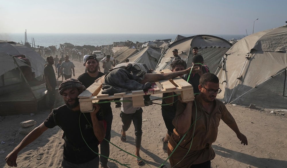 Palestinians carry the body of a man who was hit by a truck while attempting to reach a humanitarian aid convoy that entered Gaza City from the northern Gaza Strip, Saturday, July 26, 2025. (AP)