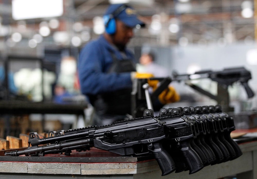 A worker assembles a Galil-GT assault rifle at the Colombian based military weapons manufacturer, Indumil, in Soacha, Colombia. (AP)