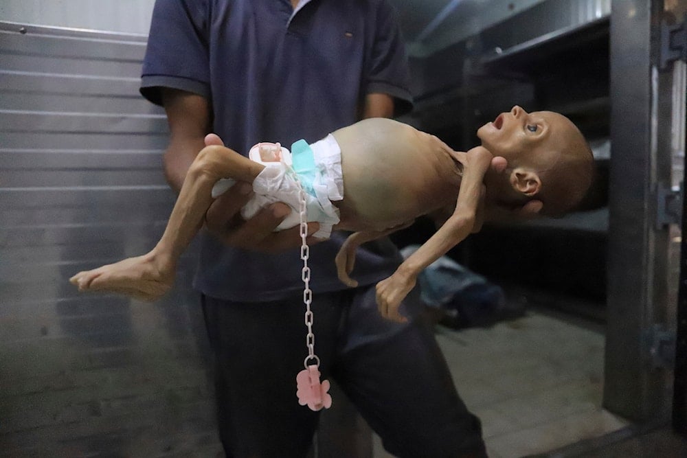 Mourners pray over the tiny body of Soad Qeshtah, who died hours after being delivered from her mother, seven-months pregnant Soad al-Shaer, killed in an overnight Israeli airstrike on Khan Younis in the Gaza Strip, Monday, July 28, 2025. (AP)