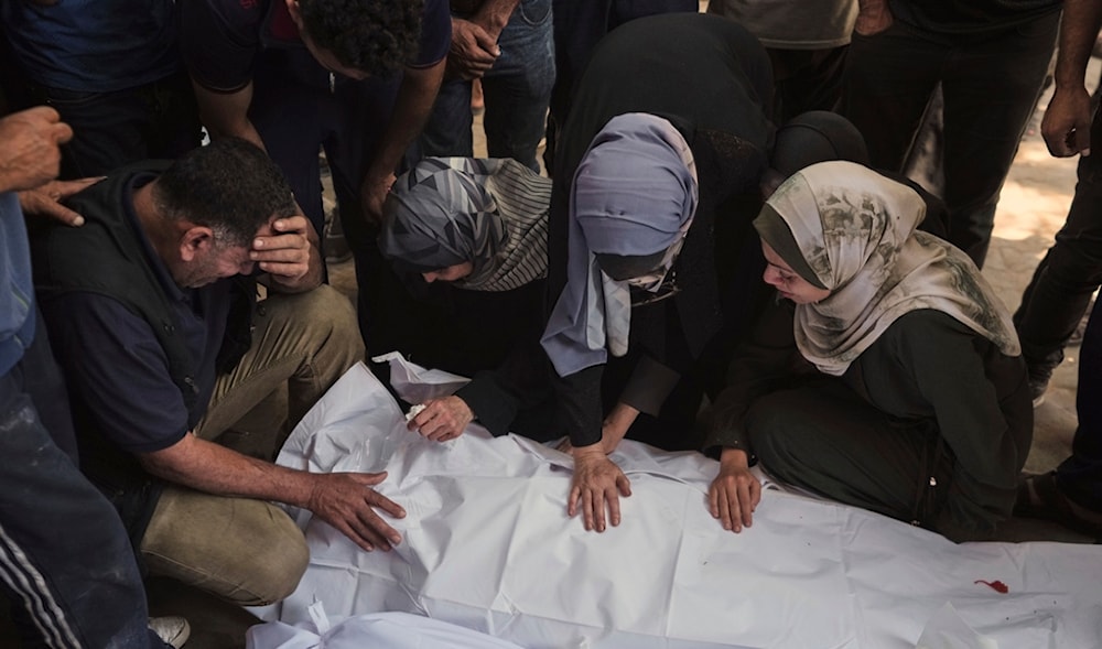 Mourners bids farewell to their relatives, Duha Hajila and her three children who were killed by an Israeli airstrike that struck a school used as a shelter, in Shifa Hospital in Gaza City, on Thursday, July 3, 2025. (AP)