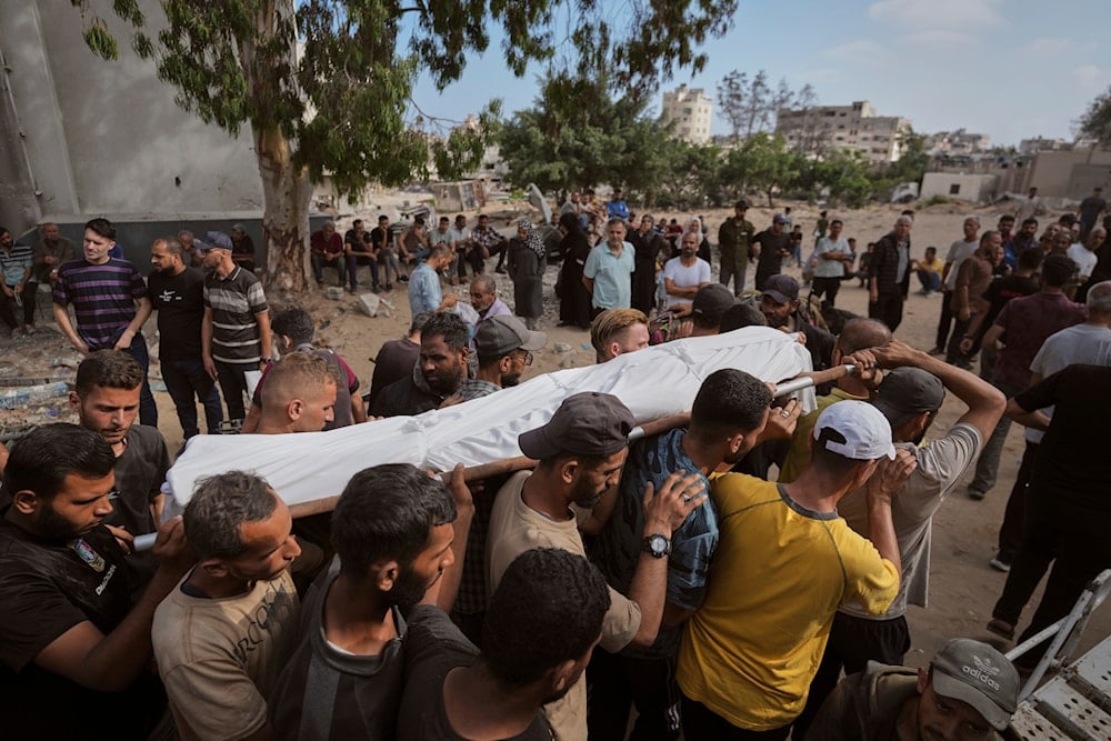 Mourners carry the body of a Palestinian man, who was killed while heading to an aid distribution hub, during his funeral in Gaza City, Thursday, July 3, 2025 (AP)