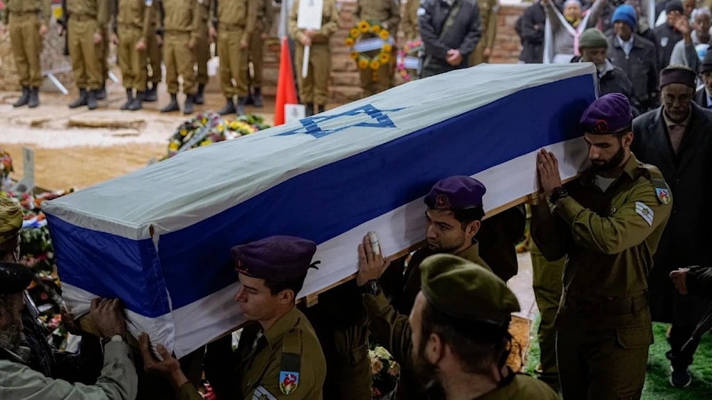 Israeli soldiers carry the flag-draped casket of Staff Sgt. Birhanu Kassie during his funeral, al-Quds, Occupied Palestine, Sunday, Dec. 24, 2023 (AP)