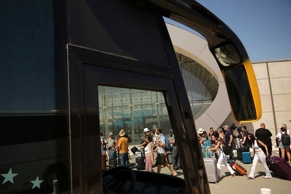 Israelis line up at the entrance to the departures terminal at Cyprus' main port in Limassol, on Saturday, June 21, 2025. (AP)