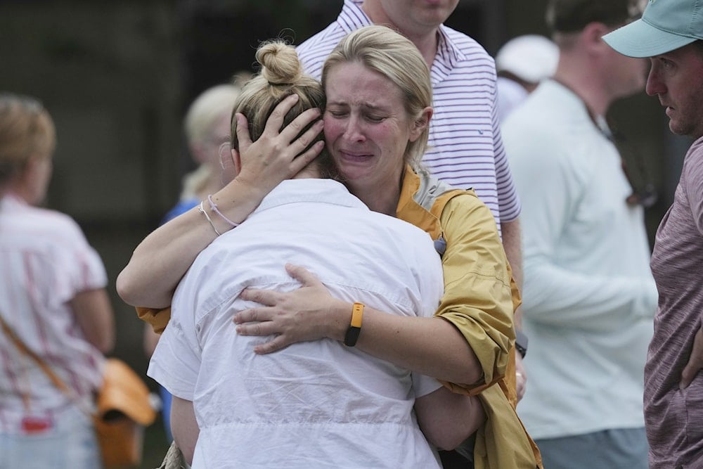 Families are reunited at a reunification center after flash flooding hit the area, Friday, July 4, 2025, in Ingram, Texas. (AP Photo/Eric Gay)