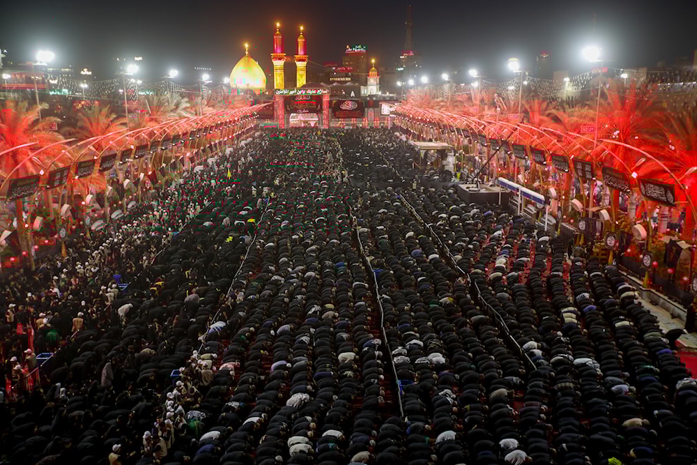 Iraqi Shiites take part in Ashura that marks the martyrdom of Hussain ibn Ali, a grandson of the Islamic prophet Muhammad, and members of his immediate family in the Battle of Karbala, in Karbala, Iraq, Monday, Aug. 8, 2022. (AP)