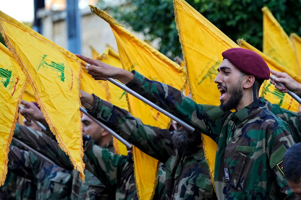 Hezbollah resistance fighters raise their flags and chant slogans as they attend the funeral procession of Hezbollah commanders Ibrahim Kobeisi and Hussein Ezzedine in Beirut's southern suburb, Wednesday, Sept. 25, 2024. (AP)