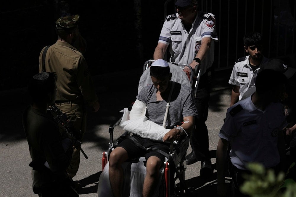 A wounded soldier arrives for the funeral of an Israeli soldier, who was killed in action in the Gaza Strip, at Mt. Herzl Military Cemetery in occupied al-Quds, occupied Palestiine, Tuesday, July 8, 2025 (AP)