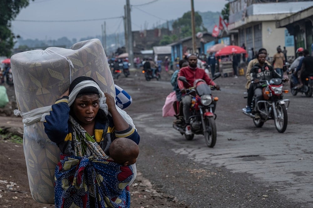 People displaced by the fighting with M23 rebels make their way to the center of Goma, Democratic Republic of the Congo, on January 26, 2025. (AP Photo/Moses Sawasawa, File)