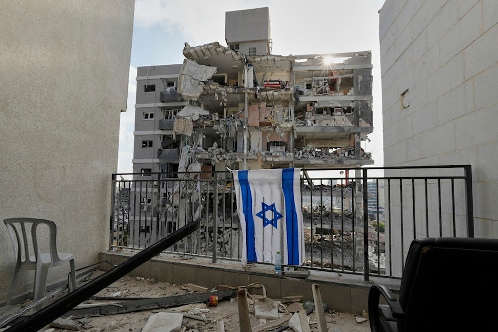 Destruction of residential buildings by an Iranian missile strike in Bat Yam, central occupied Palestine, on Sunday, June 15, 2025 (AP)