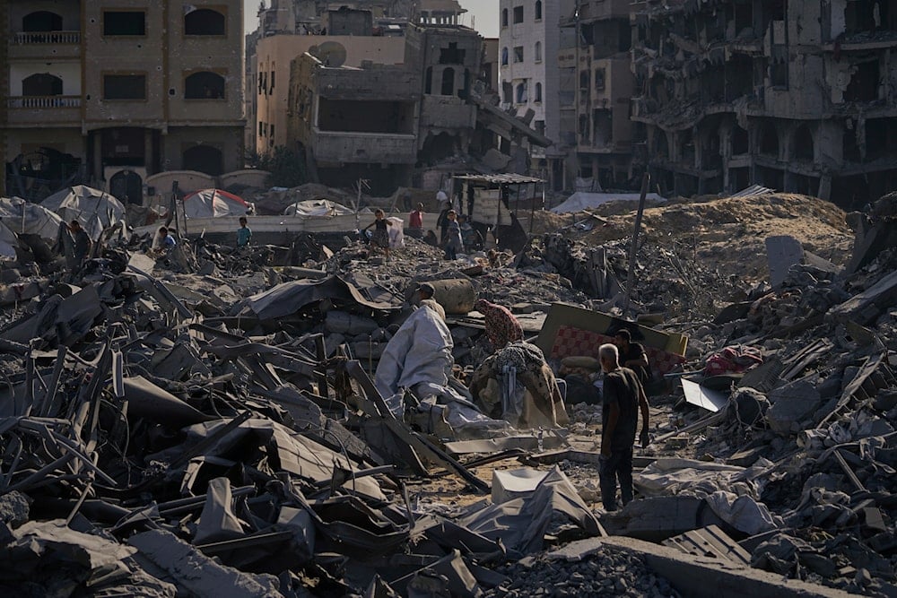 People inspect the damage at the Sheikh Radwan al-Taba UNRWA clinic following an Israeli army bombardment in Gaza City Wednesday, Aug. 6, 2025 (AP)