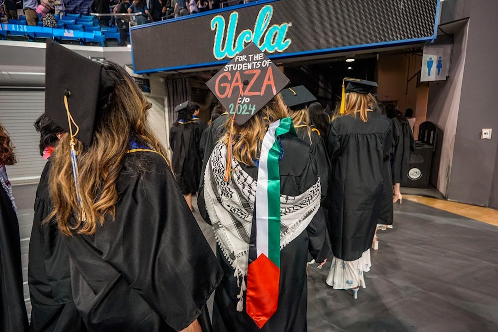 Students walk to take part a commencement ceremony inside Pauley Pavilion on UCLA campus, in Los Angeles, Friday, June 14, 2024 (AP)
