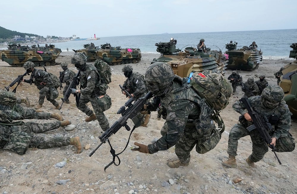 South Korean Marines run out from amphibious assault vehicles after landing on the beach during the combined military amphibious landing exercise between South Korea and the US, called Ssangyong exercise, in Pohang, South Korea, Monday, Sept. 2, 2024 (AP)