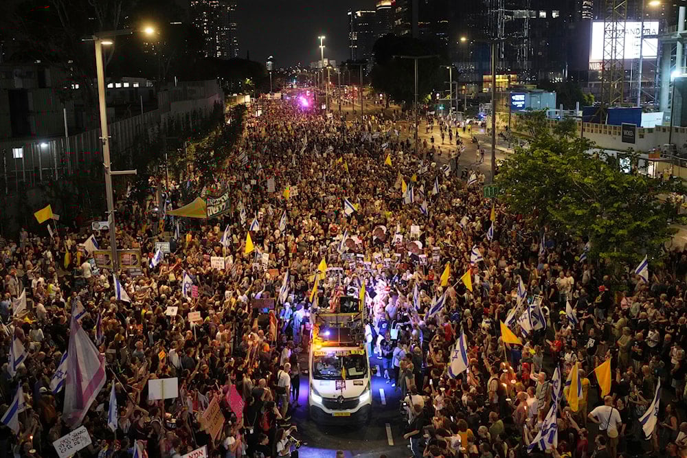 Relatives and supporters of Israeli captives attend a rally demanding their release and calling for an end to the war on Gaza, in Tel Aviv, Occupied Palestine, Saturday, Aug. 9, 2025 (AP)