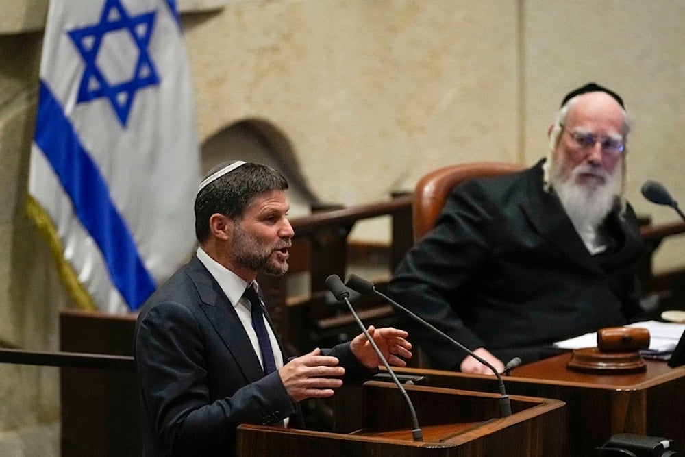 Far-right Israeli Finance Minister Bezalel Smotrich speaks at the Knesset, in occupied al-Quds, occupied Palestine, Monday, July 10, 2023 (AP)