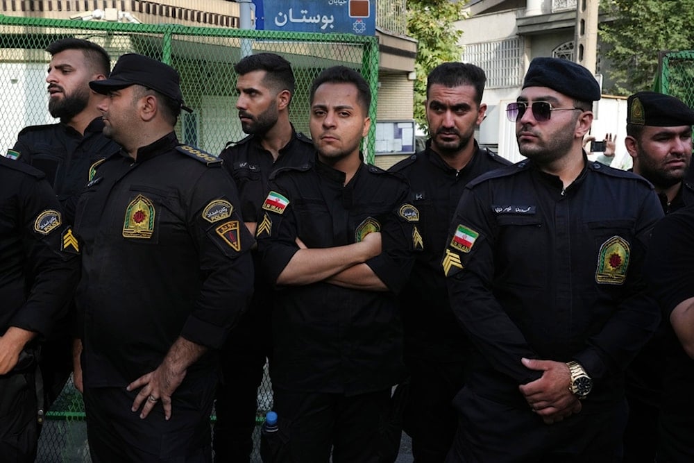 Iranian police officers stand guard during a protest against Sweden in front of the Swedish Embassy in Tehran, Iran, Friday, July 21, 2023 (AP)
