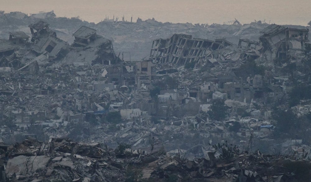Buildings that were destroyed during the Israeli ground and air operations stand in the northern Gaza Strip as seen from southern Israel, Friday, Aug. 8, 2025. (AP Photo/Leo Correa)