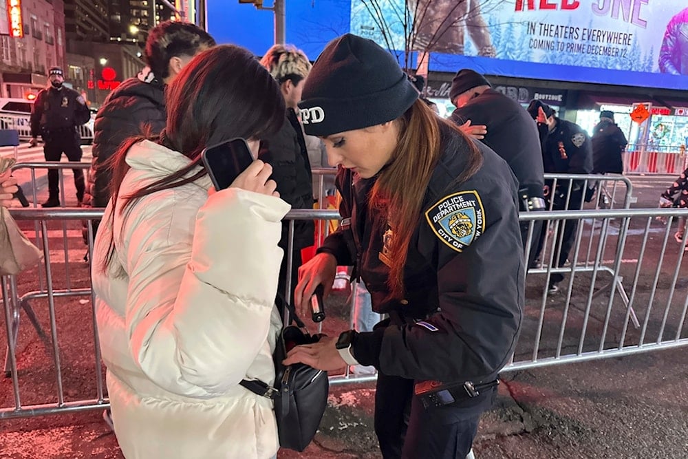 NYPD officers search people entering Times Square in New York for the New Year's Eve celebration on Tuesday, December 31, 2024 (AP)