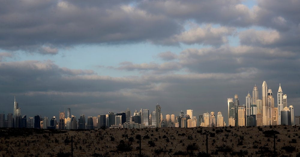 The sunrise reflects on city skylines at the Marina and Jumeirah Lake Towers districts in Dubai, United Arab Emirates, on February 27, 2021. (AP Photo/Kamran Jebreili)