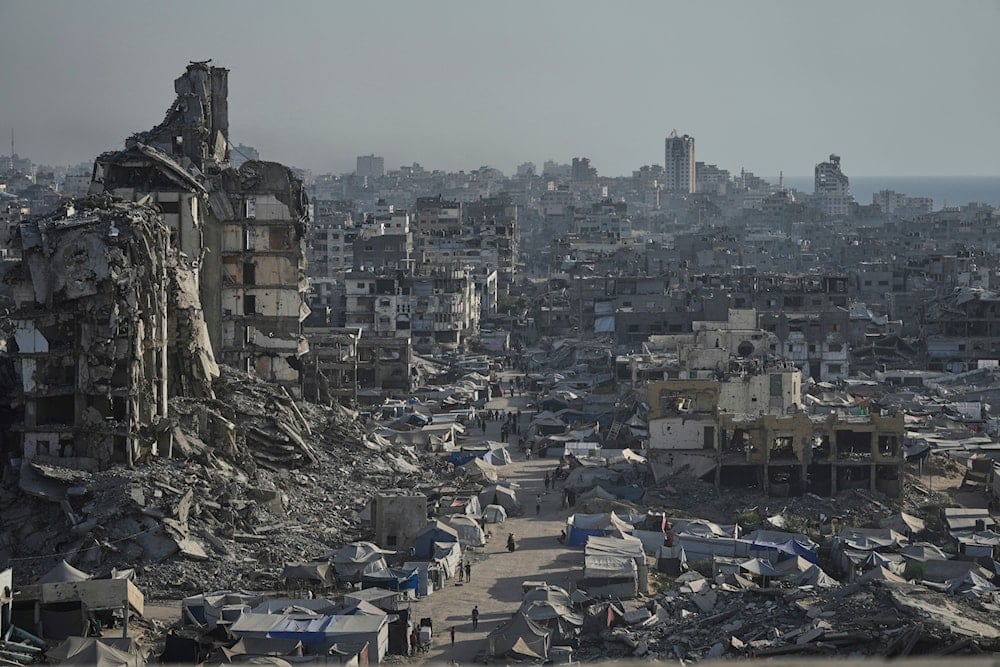 Tents sheltering displaced Palestinians are seen amid war-damaged infrastructure in Gaza City, on July 17, 2025. (AP Photo/Jehad Alshrafi)