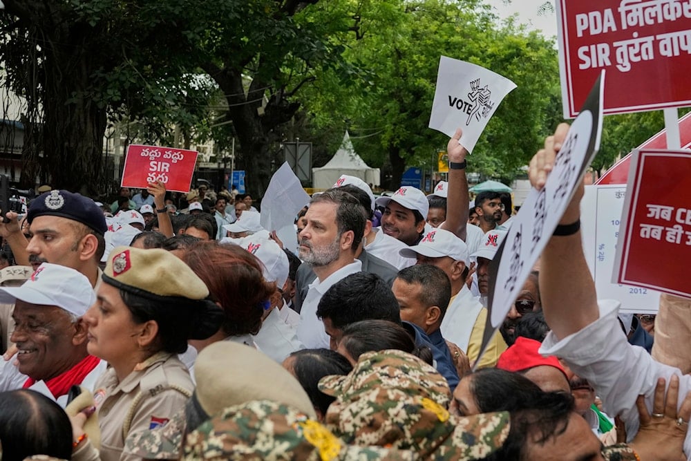 Congress party leader and leader of opposition Rahul Gandhi, center, and other parties lawmakers are stopped by police during a protest, in New Delhi, India, Monday, Aug. 11, 2025 (AP)