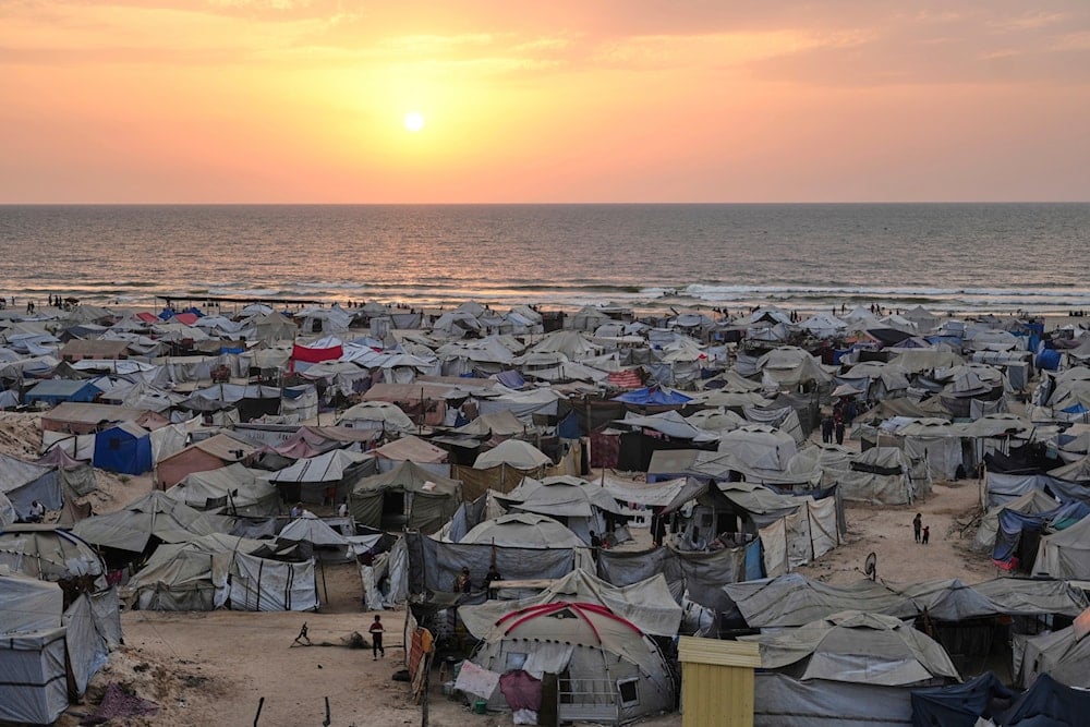 Tents housing displaced Palestinians crowd the beach in Gaza City, as the sun sets over the Mediterranean Sea, Sunday, Aug. 10, 2025 (AP)