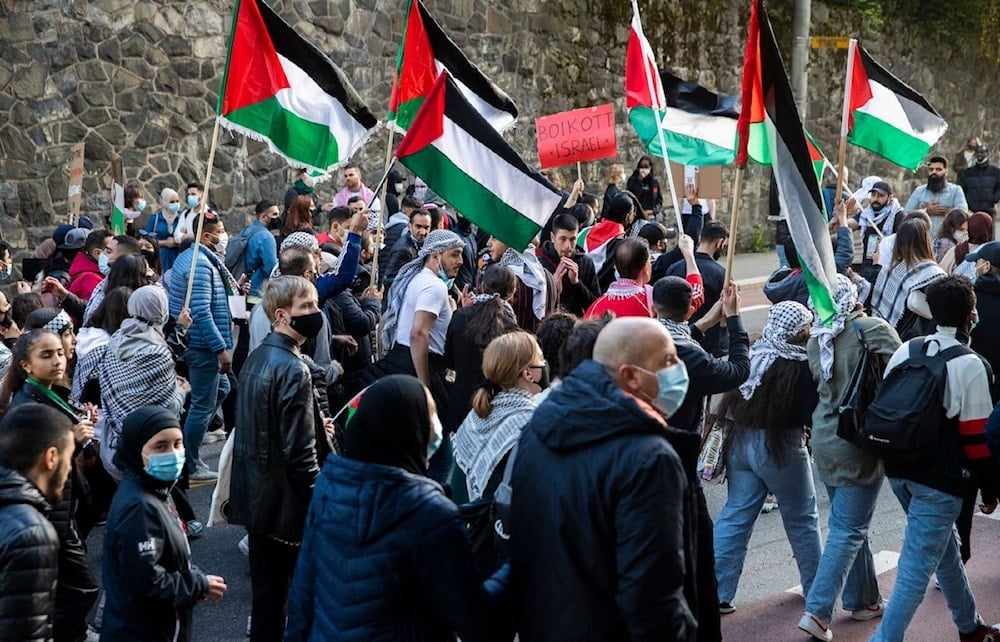 Demonstrators wave Palestinian flags as people gather in Oslo, Norway, in solidarity with the Palestinians in the Gaza Strip (BERIT ROALD/NTB/AFP via Getty Images)